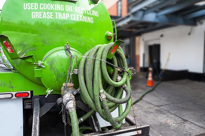 a service truck pumping grease from a restaurant's grease trap in Dundee, FL